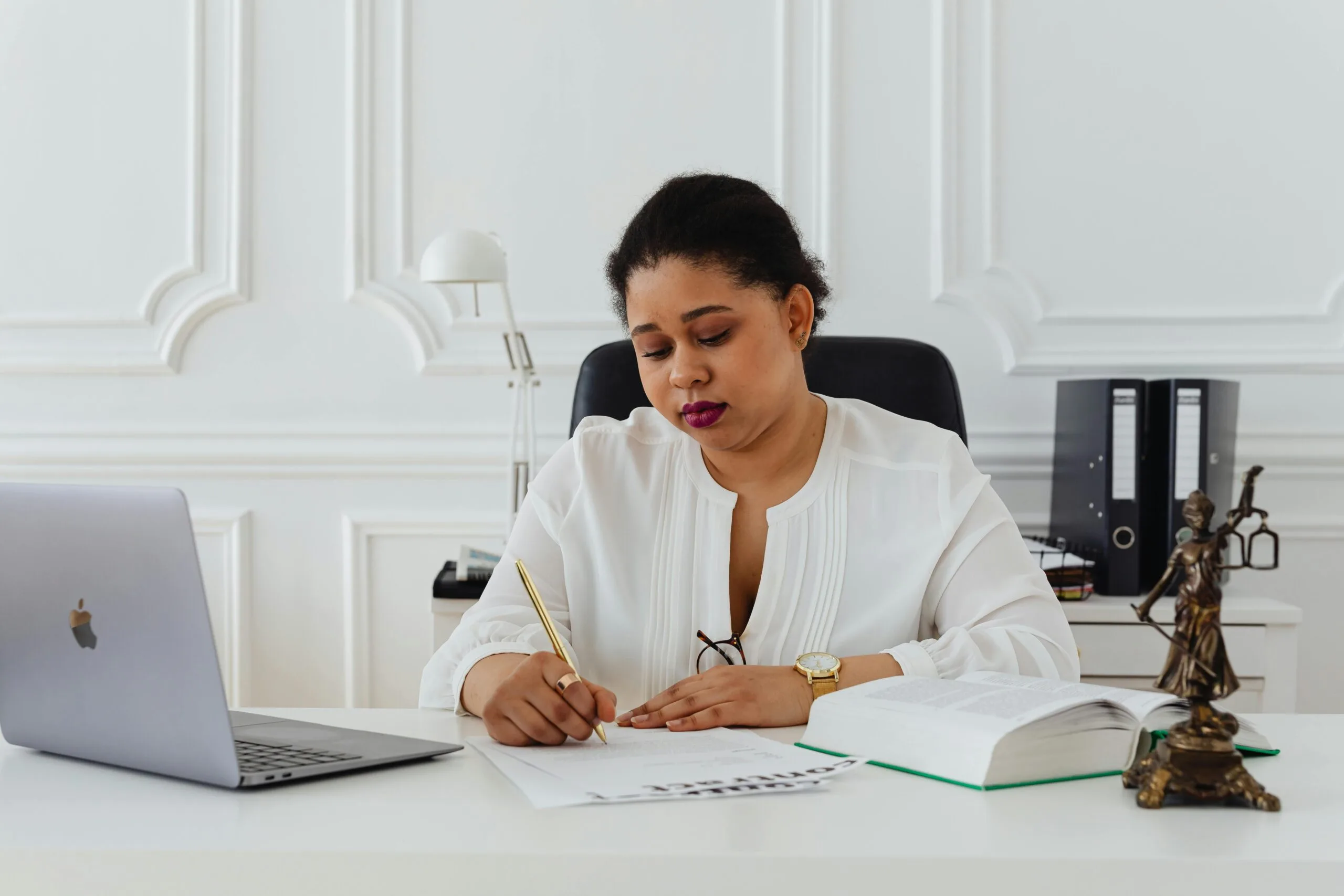 A woman is writing on the paper
