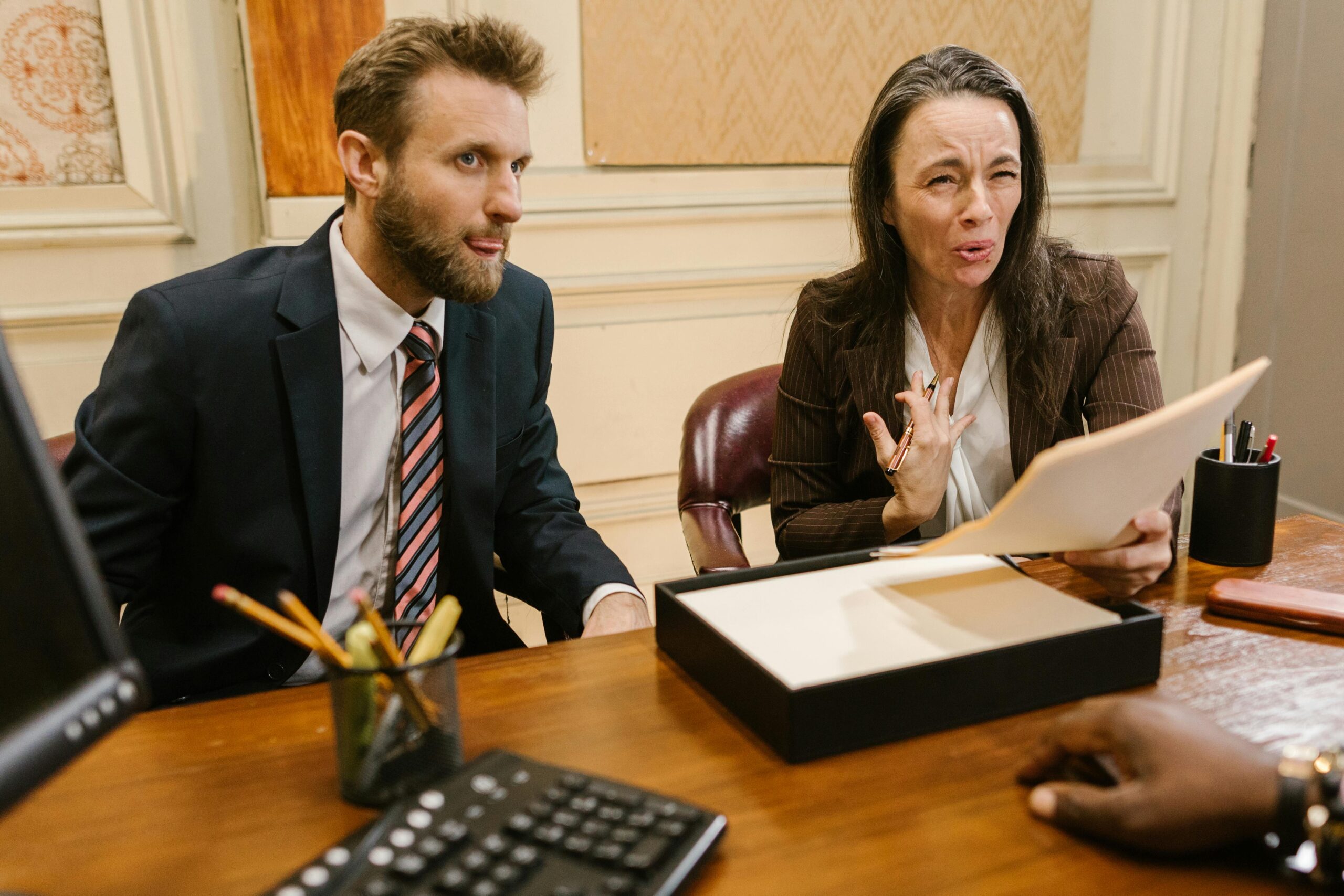 A man is sitting, and woman seems to be angry