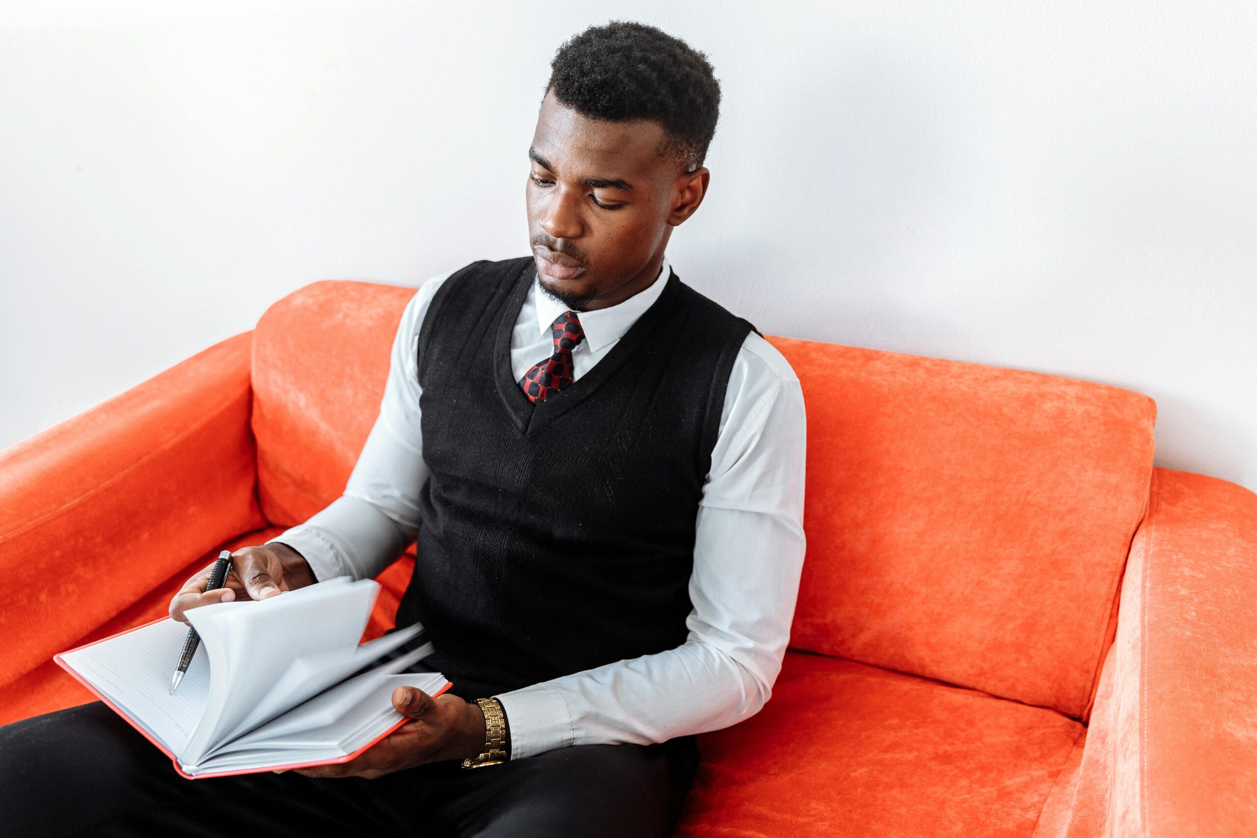 A man is sitting on the couch